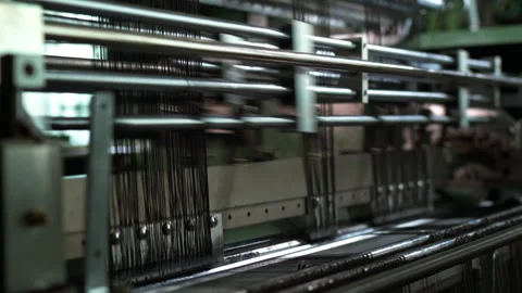 Industrial weaving machine operating with fast moving black warp threads Stock Footage 321889254