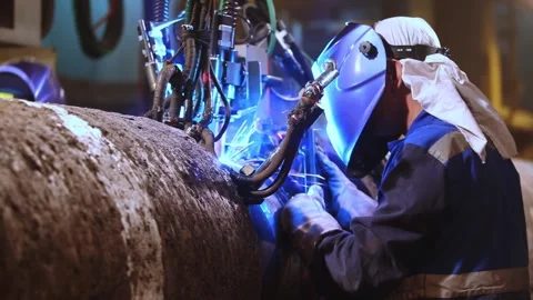 Industrial Welder Operating Automated Pipe Welding Machine with Sparks Stock Footage 341860585