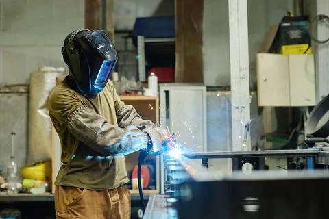 Industrial welder with torch working with metal Stock Photos