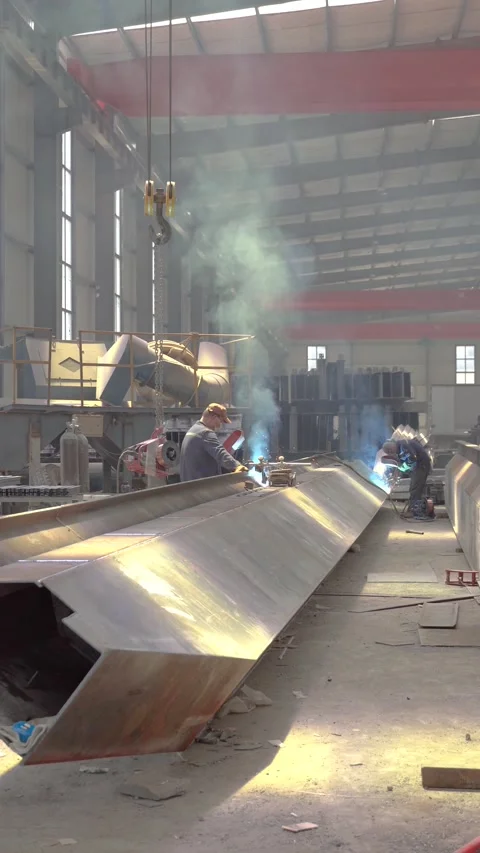 Industrial Welders Fabricating Large Structural Steel Beams in Manufacturing Stock Footage 339384342