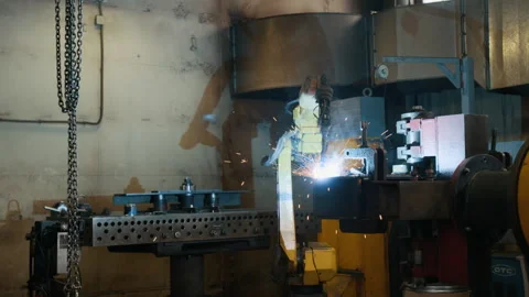 Industrial Welding Robot Joining Metal Parts in Metalworking Shop Stock Footage 320681641