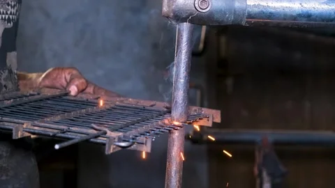 Industrial welding work on metal frame, bright sparks and smoke bursting Stock Footage 338203412
