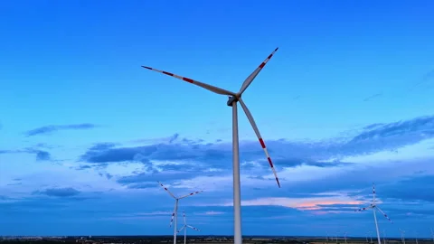 Industrial wind generator under dramatic blue twilight sky. Low angle capture of Stock Footage 339018501