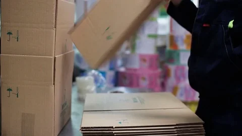Industrial worker assembles cardboard boxes Stock Footage 83442406