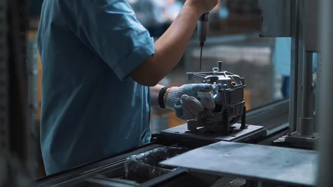 Industrial worker assembling metal appliances at automatical conveyor at factory Stock Footage 116004680