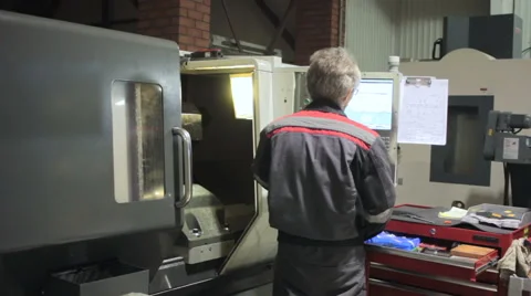 Industrial Worker. CNC Machining operator. Male worker industrial control panel Stock Footage 60250271