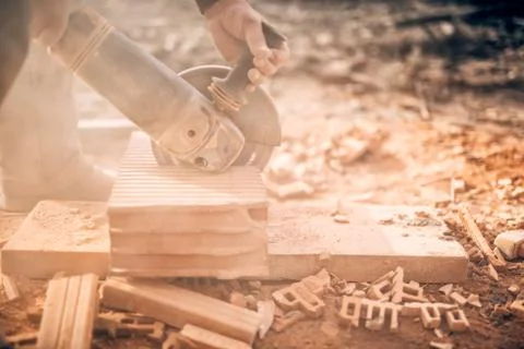 Industrial worker on construction site, working in debris and dus, sawing Stock Photos