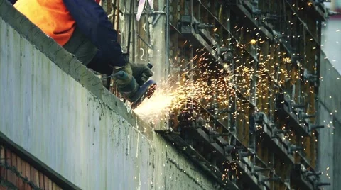 Industrial worker cuts rebar with a angle grinder, slow motion Video stock 68299556