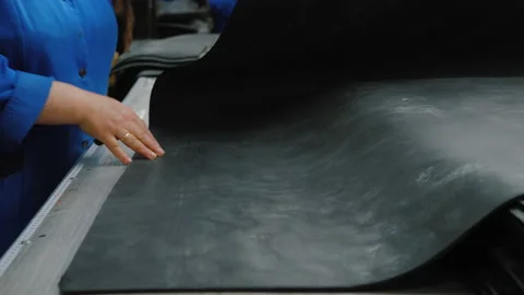 Industrial worker cuts rubber sheet, sealing rubber and gasket production Video stock 135993674