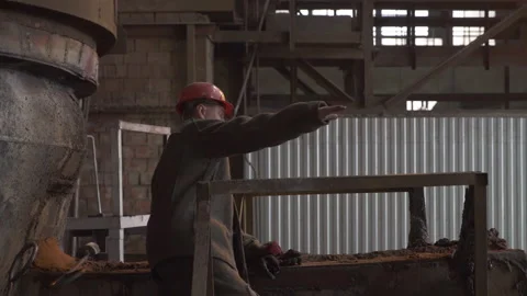 An Industrial Worker Devotedly Operating Complex Machinery in an Active Workshop Stock Footage 296762184