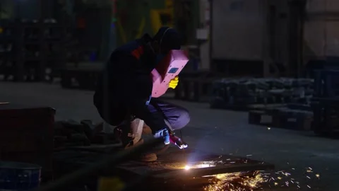 Industrial Worker at the factory welding close up. Electric wheel grinding on st Stock Footage