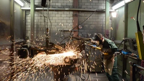 Industrial worker in a foundry machining a workpiece with a grinding machine Stock-Footage 94853703