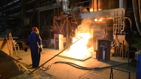 Industrial worker in a foundry working at a blast furnace Stock-Footage 94853670