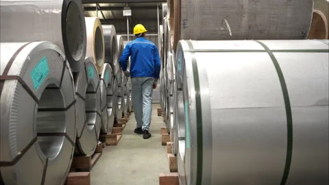 Industrial worker inspecting inside a large metal tube in a factory Stock Footage 317902757