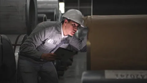 Industrial worker inspecting inside a large metal tube Stock Footage 317905575
