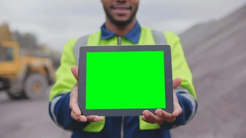 Industrial worker looking at camera, smiling and showing digital tablet screen. Stock Footage 124306295