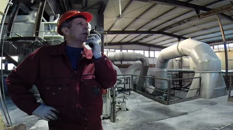 Industrial worker in manufacturing plant using radio communication Stock Footage 56766605