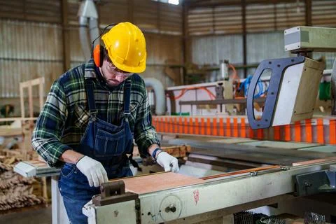 Industrial Worker Operating Conveyor Machine in Manufacturing Workshop Stock Photos