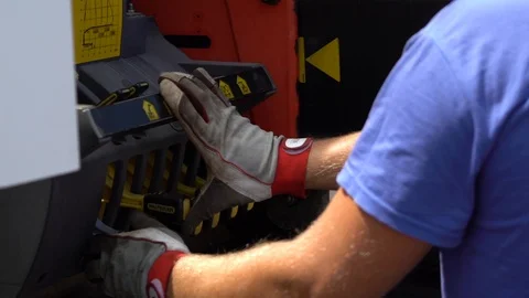 Industrial worker is operating a high tech drill using levers Stock Footage 102493670