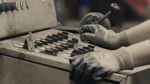 Industrial worker operating machine on control panel in metal industry.  Video stock 120821937
