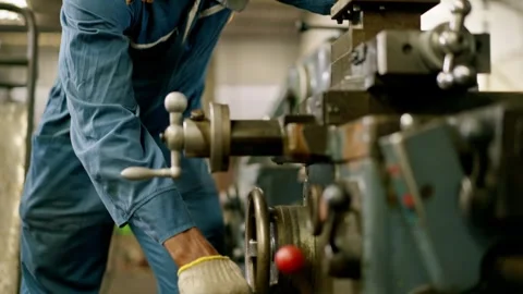 Industrial worker operating machine in factory manufacturing metal machinin.. Stock Footage 332503223