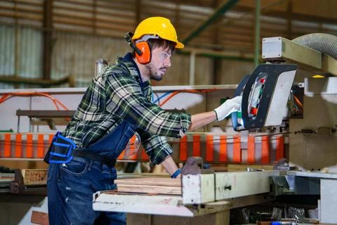 Industrial Worker Operating Manufacturing Machine in Factory Stock Photos