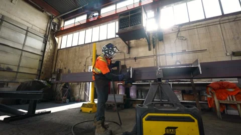Industrial Worker Preparing Structural Steel Beam for Welding Inside Fabrication Stock Footage 330805643