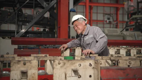 Industrial worker in protective gear experiencing chest pain Stock Footage 317904962
