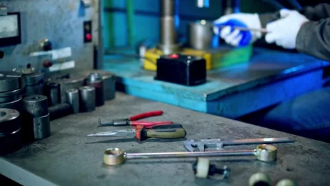 Industrial worker in protective gloves assembles metal parts at factory mac.. Stock Footage 337682784