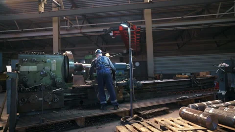 Industrial Worker Skillfully Operating Heavy Machinery in a Factory Setting with 動画素材 310313915