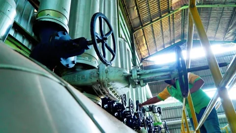 Industrial Worker Turning Large Manual Valve in Factory Plant Facility Stock Footage 335080805