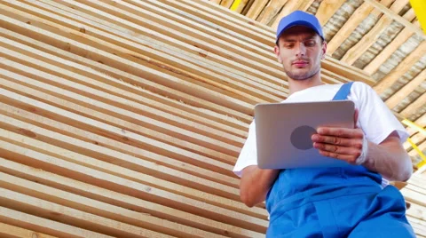 Industrial worker in uniform checking large wooden box on tablet in warehouse Stock Footage 57094748