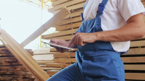Industrial worker in uniform checking large wooden box on tablet in warehouse Stock Footage 57095113