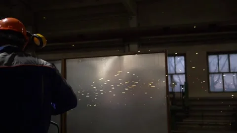 Industrial Worker Using Angle Grinder And Cutting, sparks, slow motion Stock Footage 130775815