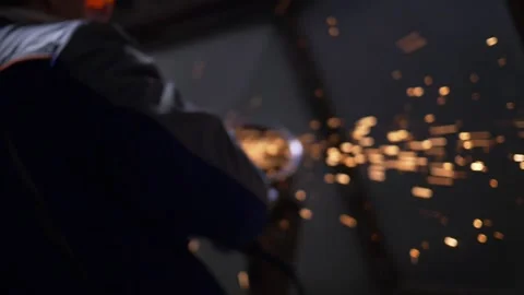 Industrial Worker Using Angle Grinder And Cutting, sparks, slow motion, defocus Video stock 130776037