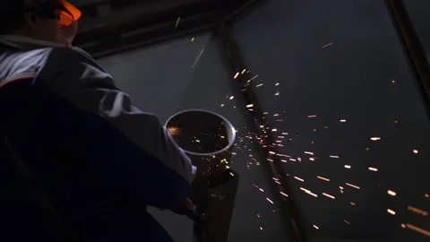 Industrial Worker Using Angle Grinder And Cutting, sparks, slow motion Stock Footage 130776390