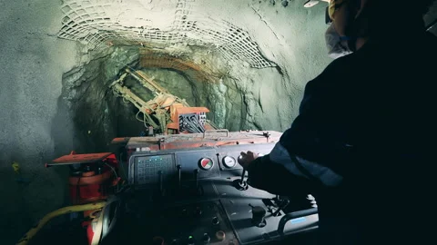 Industrial worker is using a boring mechanism to irrigate a mine Video stock 153024123