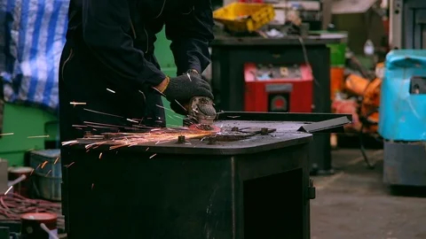 Industrial worker using grinding machine with metal at factory. Stock Footage 125290468