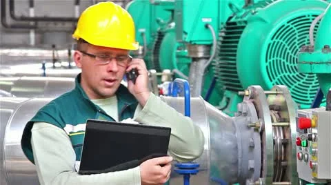 Industrial worker using a phone and notebook Stock Footage 24672624