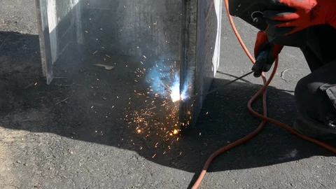 Industrial worker welding  at the construction site in daytime. Sparks fly as on Video stock 97821174