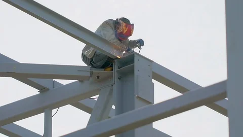 Industrial worker welding of metal structures, welder man male worker soldering Stock Footage 98362038