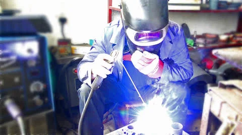 Industrial worker welding, welder uses torch to make sparks during manufactur Stock Footage