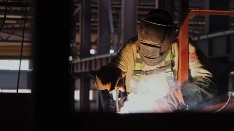Industrial worker welds metal structures on construction site Stock Footage 121644847