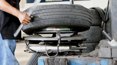 Industrial worker working with tire machine in garage. Stock Footage 37608248