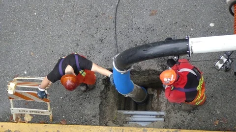 Industrial workers fixing drain Stock Footage 72269988