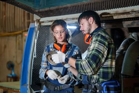 Industrial Workers Inspecting a Metal Component in Factory Workshop Stockfoto's