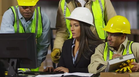 Industrial workers look over files Stock Footage 61676447