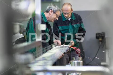 Industrial Workers In Manufacturing Plant.