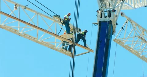 Industrial workers prepare crane assembly at construction site development 4K Stock Footage 66366155