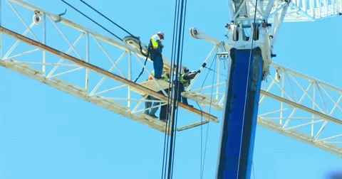 Industrial workers prepare crane assembly at construction site development 4K Stock Footage 66366276